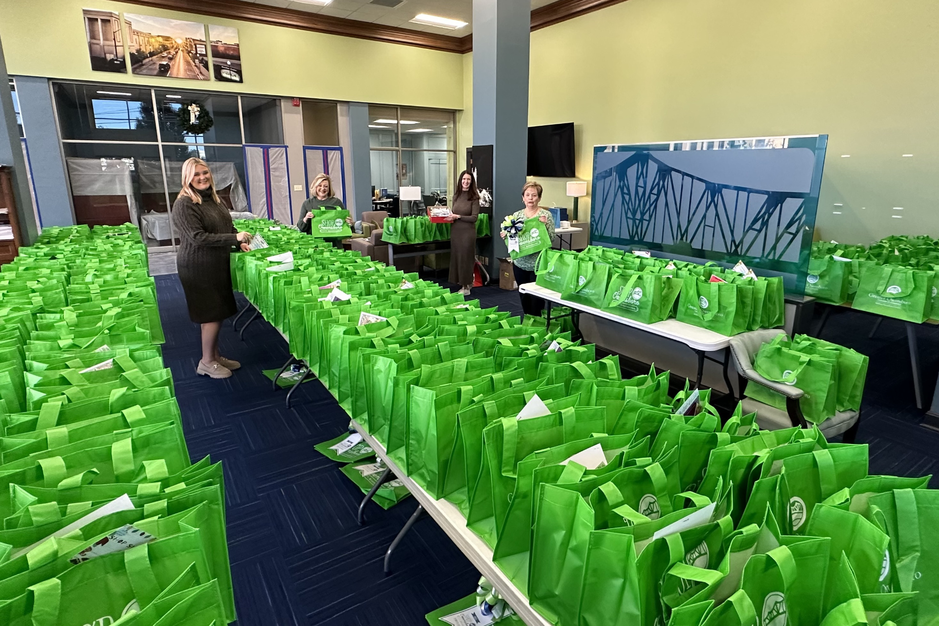 Chamber staff prepare tote bags for Shop Owensboro